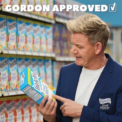 Chef examining Welch's Fruit Snacks box in a store aisle.