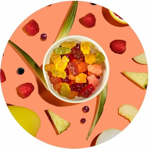 Bowl of gummy bears surrounded by fruit slices and berries on an orange background.