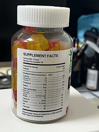 Bottle of hemp extract gummies with supplement facts label.